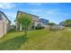Spacious backyard with green lawn and well-maintained landscaping, offering ample space for activities at 1476 Fort Cobb Ter, Wesley Chapel, FL 33543