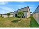 Spacious backyard with green lawn and well-maintained landscaping, offering ample space for activities at 1476 Fort Cobb Ter, Wesley Chapel, FL 33543