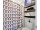 Bathroom featuring shelves with decor, a toilet, and a shower with decorative curtain at 1476 Fort Cobb Ter, Wesley Chapel, FL 33543