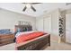Comfortable bedroom featuring a ceiling fan, closet, and bedside table, creating a relaxing space at 1476 Fort Cobb Ter, Wesley Chapel, FL 33543