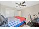 Comfortable bedroom featuring a ceiling fan, a desk with a gaming setup, and a closet at 1476 Fort Cobb Ter, Wesley Chapel, FL 33543