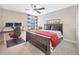 Comfortable bedroom featuring a ceiling fan, a desk with a gaming setup, and a large window at 1476 Fort Cobb Ter, Wesley Chapel, FL 33543