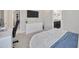Bright bedroom featuring a TV, desk, and comfortable bed, creating a relaxing and functional space at 1476 Fort Cobb Ter, Wesley Chapel, FL 33543