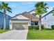 Charming two-story home with a stone accent, well-manicured lawn, and a two-car garage at 1476 Fort Cobb Ter, Wesley Chapel, FL 33543