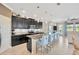 Kitchen featuring stainless appliances, granite countertops, an island with seating, and open floorplan to the living area at 1476 Fort Cobb Ter, Wesley Chapel, FL 33543