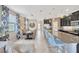 Open-concept living room featuring an island bar and dining room at 1476 Fort Cobb Ter, Wesley Chapel, FL 33543