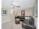 Comfortable living room featuring a modern sofa, dark wood table, and decorative artwork at 1476 Fort Cobb Ter, Wesley Chapel, FL 33543