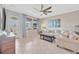 Bright living room with tile flooring, a large sofa, and lots of natural light from the windows at 1476 Fort Cobb Ter, Wesley Chapel, FL 33543