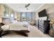 Bright main bedroom featuring neutral walls, ceiling fan, nice windows, and an ensuite bathroom at 1476 Fort Cobb Ter, Wesley Chapel, FL 33543