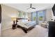 Main bedroom with a ceiling fan, natural light, and neutral decor and large windows at 1476 Fort Cobb Ter, Wesley Chapel, FL 33543