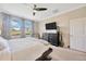 Inviting main bedroom with neutral decor, ceiling fan, an ensuite bathroom, and a dresser at 1476 Fort Cobb Ter, Wesley Chapel, FL 33543
