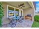 Inviting covered patio featuring a dining table, ceiling fan, and tiled floor for outdoor enjoyment at 1476 Fort Cobb Ter, Wesley Chapel, FL 33543