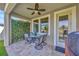 Cozy patio with outdoor seating, a ceiling fan, and a lush green wall for added privacy at 1476 Fort Cobb Ter, Wesley Chapel, FL 33543