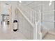 Open staircase with modern wainscoting and neutral color palette at 1476 Fort Cobb Ter, Wesley Chapel, FL 33543