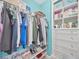 Organized walk-in closet with shelves and clothing racks provides ample storage space and a delightful design at 1476 Fort Cobb Ter, Wesley Chapel, FL 33543