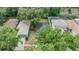 This is a top down view of the home with mature trees and a screened in pool at 1524 Marsh Wood Dr, Seffner, FL 33584