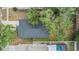 Aerial top-down view of a house with mature tree coverage and a neighboring pool at 1524 Marsh Wood Dr, Seffner, FL 33584