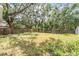 Backyard featuring partial wood fence and shade trees at 1524 Marsh Wood Dr, Seffner, FL 33584