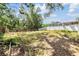 Large backyard featuring a partial fence and mature trees at 1524 Marsh Wood Dr, Seffner, FL 33584