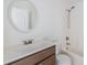 Bathroom featuring a large mirror, single sink vanity, and a tub with shower at 1524 Marsh Wood Dr, Seffner, FL 33584