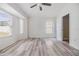 Bright, airy bedroom featuring sleek wood-look flooring and a modern ceiling fan at 1524 Marsh Wood Dr, Seffner, FL 33584