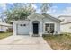 Charming single-Gathering home featuring an attached garage and inviting front entrance at 1524 Marsh Wood Dr, Seffner, FL 33584