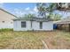 Rear exterior view of home with a partially fenced yard at 1524 Marsh Wood Dr, Seffner, FL 33584