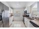 A well-lit kitchen features white cabinets, tile floor, and stainless steel appliances at 1524 Marsh Wood Dr, Seffner, FL 33584