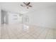 A bright living room with tile flooring, ceiling fan, and natural light from the window at 1524 Marsh Wood Dr, Seffner, FL 33584