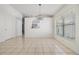 This is a bright dining area with a view to the kitchen and a modern light fixture at 1524 Marsh Wood Dr, Seffner, FL 33584