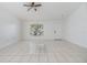 Bright living room features tile flooring, ceiling fan, and a large window at 1524 Marsh Wood Dr, Seffner, FL 33584