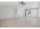 Open living area with tile floors, ceiling fan, and a view of the kitchen at 1524 Marsh Wood Dr, Seffner, FL 33584