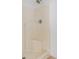 Shower with white tile surround and built-in corner shelf at 1524 Marsh Wood Dr, Seffner, FL 33584