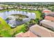 Aerial view of homes surrounding a picturesque lake in a vibrant community at 15707 Crystal Waters Dr, Wimauma, FL 33598