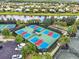 Community aerial view showcasing tennis courts, shuffleboard and bocce ball in a sunny neighborhood at 15707 Crystal Waters Dr, Wimauma, FL 33598