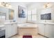 Luxurious bathroom with soaking tub, dual vanities, and decorative art at 15707 Crystal Waters Dr, Wimauma, FL 33598