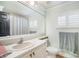 Bright bathroom features a vanity with a large mirror and combination shower and tub at 15707 Crystal Waters Dr, Wimauma, FL 33598