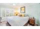 Inviting bedroom filled with natural light and featuring plantation shutters at 15707 Crystal Waters Dr, Wimauma, FL 33598