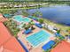 The community features multiple swimming pools, a lazy river and lounging area, overlooking a scenic lake at 15707 Crystal Waters Dr, Wimauma, FL 33598