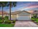Charming single-Gathering home with well-manicured landscaping, brick driveway, and a serene dusk sky backdrop at 15707 Crystal Waters Dr, Wimauma, FL 33598