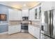 Updated kitchen featuring stainless steel appliances and white cabinetry at 15707 Crystal Waters Dr, Wimauma, FL 33598