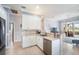 Bright kitchen with stainless steel appliances, tile backsplash, and ample counter space at 15707 Crystal Waters Dr, Wimauma, FL 33598