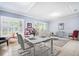 Beautifully staged living room with plantation shutters, recessed lights, and stylish decor at 15707 Crystal Waters Dr, Wimauma, FL 33598
