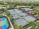 Community amenities include multiple tennis courts, perfect for friendly matches or serious training, surrounded by landscaping at 15707 Crystal Waters Dr, Wimauma, FL 33598