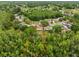 Aerial view showcasing the property lines highlighting a home with mature trees at 16116 Manorwood Cir, Tampa, FL 33624