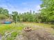 Backyard with fire pit, pond view and ample space for outdoor activities and entertaining at 16116 Manorwood Cir, Tampa, FL 33624