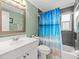 Bathroom featuring patterned shower curtain, large mirror and white vanity at 16116 Manorwood Cir, Tampa, FL 33624