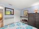 Bedroom with blue walls, a large window, and a dresser at 16116 Manorwood Cir, Tampa, FL 33624
