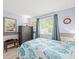 Bedroom with blue walls, a large window, and a dresser at 16116 Manorwood Cir, Tampa, FL 33624