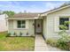 Charming home exterior showcasing well-maintained landscaping and a welcoming front entrance at 16116 Manorwood Cir, Tampa, FL 33624